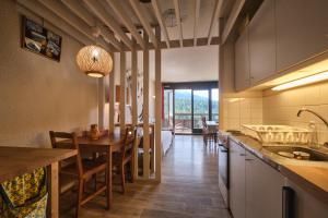 a kitchen and dining room with a table and chairs at Cosy and nice view on mountains in Villard-de-Lans
