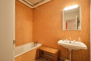 a bathroom with a sink and a mirror and a tub at Cosy and nice view on mountains in Villard-de-Lans +10 photos