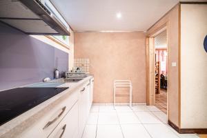 a kitchen with a sink and a stool at Chalet la Bartavelle - Morillon in Morillon