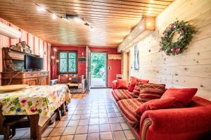 a living room with a couch and a table at Chalet la Bartavelle - Morillon in Morillon