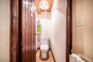 a bathroom with a white toilet in a hallway at Chalet la Bartavelle - Morillon in Morillon +18 photos