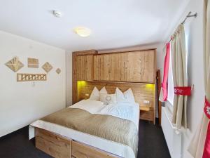 a bedroom with a large bed in a room at Apartment Naviser Hütte-2 by Interhome in Navis