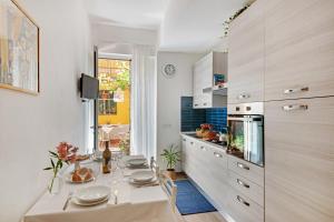 a kitchen with a table with plates on it at Un'oasi al Mare in Moneglia