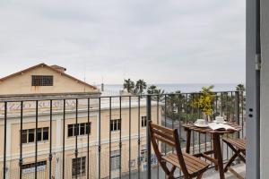 a balcony with a table and a view of a building at Puntodivista in Loano