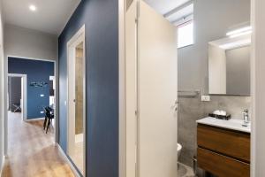 a bathroom with blue walls and a sink and a toilet at Puntodivista in Loano +18 photos