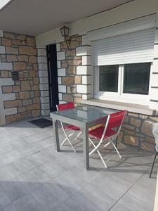 a table and two chairs sitting on a patio at La Clematite d'Olt in Saint-Côme-dʼOlt