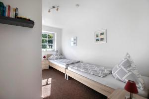 a room with a bed and a window at Ferienwohnung Andresen Högel in Högel