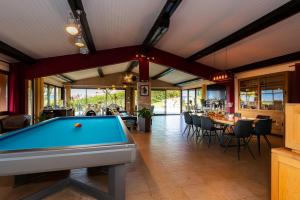 a pool table in a room with a bar at Maison avec Piscine, Spa et Jacuzzi in Saint-Jean-dʼArvey