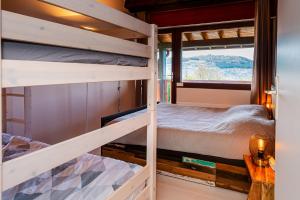 a bedroom with two bunk beds and a window at Maison avec Piscine, Spa et Jacuzzi in Saint-Jean-dʼArvey