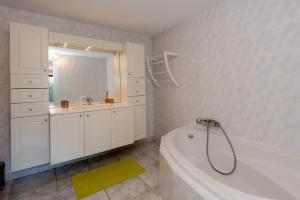 a white bathroom with a tub and a sink at Maison avec Piscine, Spa et Jacuzzi in Saint-Jean-dʼArvey +26 photos