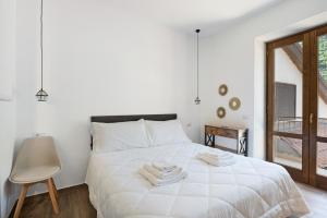a bedroom with a white bed with towels on it at La Casetta In Canada' in Agerola