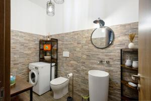 a bathroom with a toilet and a sink and a mirror at La Casetta In Canada' in Agerola +15 photos