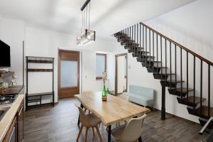 a dining room with a table and a staircase at La Casetta In Canada' in Agerola