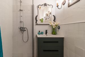 a bathroom with a sink and a mirror at Kety in Serdió +17 photos