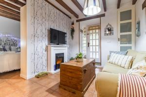 a living room with a couch and a fireplace at Kety in Serdió