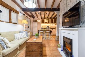 a living room with a couch and a fireplace at Kety in Serdió