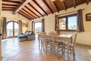 a kitchen and living room with a table and chairs at Pretziosa in Castiadas