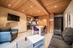 a living room with a couch and a table at L' Abbaye in Abondance