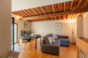 a living room with a couch and a table at Villa Adora Holiday Home in Serravalle Pistoiese