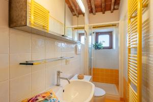 a bathroom with a sink and a toilet at Villa Adora Holiday Home in Serravalle Pistoiese +19 photos
