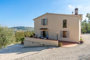 a small white house with a roof at Villa Adora Holiday Home in Serravalle Pistoiese