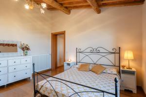 a bedroom with a bed and a dresser at Villa Adora Holiday Home in Serravalle Pistoiese