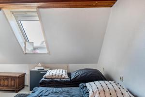 a bedroom with a bed and a window at Storchennest in Ludwigsburg