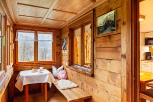 a dining room in a log cabin with a table and chairs at Ferienhaus Dünser in Bizau