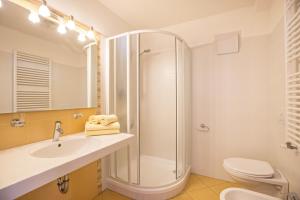 a bathroom with a shower and a sink and a toilet at Runcac Apt Pla in San Vigilio Di Marebbe +17 photos