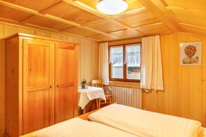 a bedroom with two beds and a table and a window at Ferienhaus Dünser in Bizau