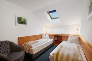 a room with two beds and a chair in it at Loderhof Sand in Taufers in Sand in Taufers
