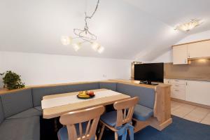a small kitchen with a table and a television at Loderhof Sand in Taufers in Sand in Taufers