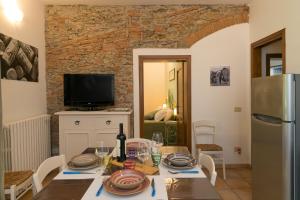 a kitchen and dining room with a table and a refrigerator at Podere Nuti - 1 La Regola in Cecina