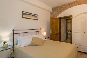 a bedroom with a large bed in a room at Podere Nuti - 1 La Regola in Cecina +21 photos