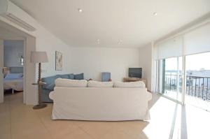 a living room with a white couch and a television at Casa Can Alou in Felanitx