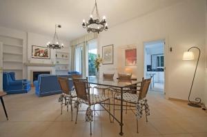 a dining room and living room with a table and chairs at Casa Can Alou in Felanitx