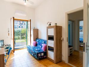 a living room with a chair and a table at Apartment Marisol by Interhome in Toirano