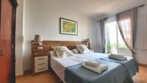 a bedroom with two beds with towels on them at Casa Can Alou in Felanitx