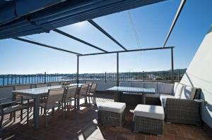 a patio with a table and chairs on a roof at Casa Can Alou in Felanitx