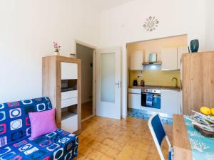 a kitchen and living room with a couch and a table at Apartment Marisol by Interhome in Toirano