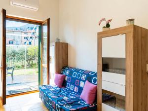 a living room with a couch and a sliding glass door at Apartment Marisol by Interhome in Toirano +26 photos
