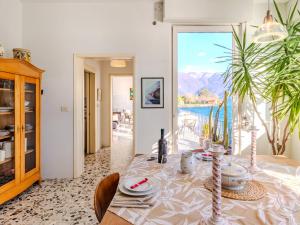 a dining room with a table and a view at Villa Casa Silvana by Interhome in Valsolda