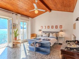 a bedroom with a bed and a ceiling fan at Villa Casa Silvana by Interhome in Valsolda