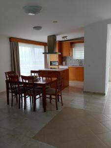 a kitchen and dining room with a table and chairs at Castle & Sea-Panorama Penthouse in Haraki