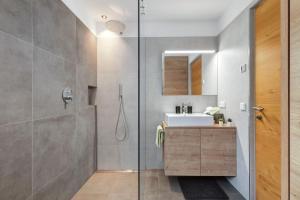 a bathroom with a sink and a shower at Appartement Sonnlicht Pfalzen in Falzes +15 photos