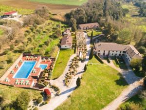 an aerial view of a mansion with a swimming pool at Borgo San Carlo in Santa Luce
