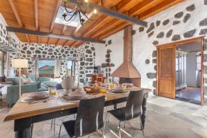 a living room with a wooden table and chairs at El Rincón de Guatisea in San Bartolomé