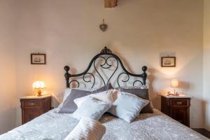 a bedroom with a large bed with pillows on it at Casa Biffoli - Bucine in Bucine