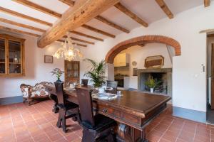 a dining room with a table and a fireplace at Casa Biffoli - Bucine in Bucine