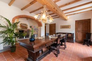 a dining room with a long table and a chandelier at Casa Biffoli - Bucine in Bucine